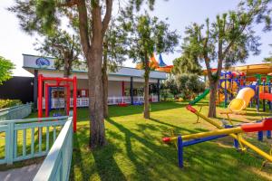 a playground in a park with trees and slides at Crystal Centro Pearl Collection - Ultimate All Inclusive in Lara