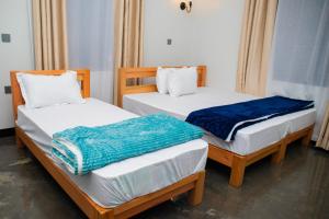 two twin beds in a room at Summit View Retreat in Moshi