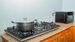 a pot on top of a stove in a kitchen at Summit View Retreat in Moshi