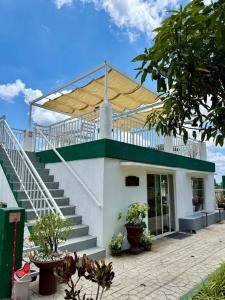 a building with a roof with stairs and a porch at The Stables by L' Rancho Danilo in Banaba