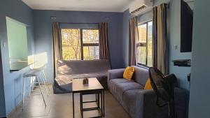 a living room with a couch and a table at Resta Lodge in Kariba