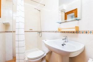 a white bathroom with a sink and a toilet at Ca n'Antonia in Sóller +22 photos