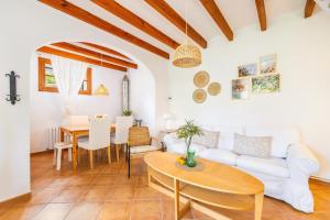 a living room with a table and a couch at Ca n'Antonia in Sóller