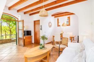 a living room with a white couch and a table at Ca n'Antonia in Sóller