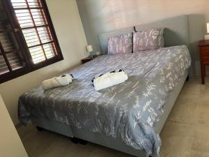 a bedroom with a bed with two towels on it at Tropical Beach Villa with Ocean View in Blue Bay +34 photos