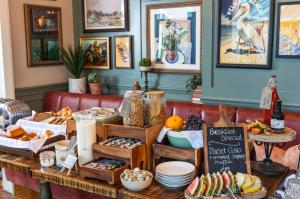 a table filled with lots of different types of food at The Canford in Poole +36 photos