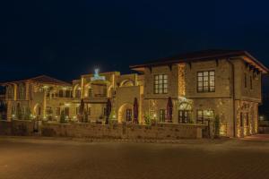 a large building with lights on it at night at Noble Blue Cappadocia in Ortahisar