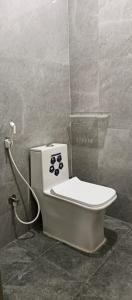 a bathroom with a toilet in a room at Happy Ladies PG in Kammasandra