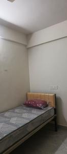 a small bedroom with a bed in a room at Happy Ladies PG in Kammasandra