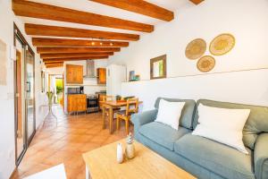 a living room with a blue couch and a table at Can Pep in Sóller