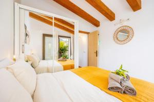 a bedroom with two beds and a mirror at Can Pep in Sóller