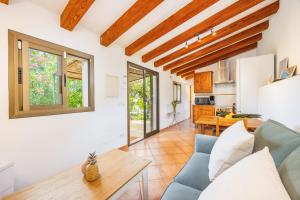 a living room with a blue couch and a table at Can Pep in Sóller