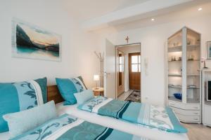 a bedroom with two beds and a mirror at Ferienappartement Donautal in Obernzell