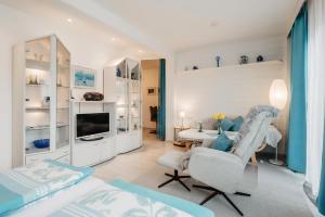 a living room with a bed and a couch and a table at Ferienappartement Donautal in Obernzell