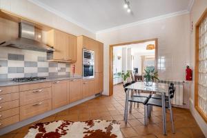 a kitchen with a table and a dining room at SUNSET Apartment in Amoreira