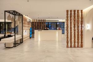 a lobby of a store with columns in a building at Hima Al Tahliyah Serviced Apartments in Jeddah