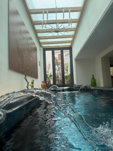 a large swimming pool with water in a building at A Ugghia in Fiumefreddo di Sicilia