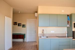 a kitchen with blue cabinets and a sink at La Papessa in Savio di Ravenna