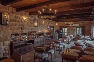 a restaurant with a bar with a bunch of chairs at Noble Blue Cappadocia in Ortahisar
