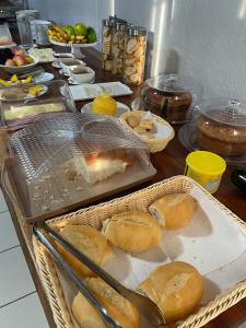 a table with baskets of bread and other food at Plaza Hotel in Itaituba