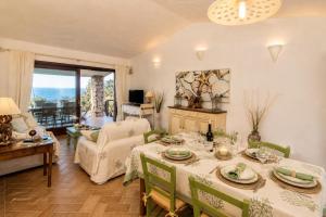 a living room with a table and a couch at Villa Turchese - Key to Villas in Costa Paradiso