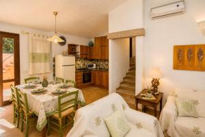 a kitchen and dining room with a table and chairs at Villa Turchese - Key to Villas in Costa Paradiso +15 photos