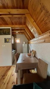 a dining room with a table and some chairs at Vikendica Anja in Žabljak
