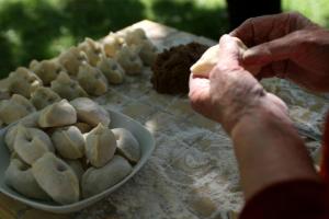 a person preparing food on a table with a bowl of food at Hotel Hvala Superior - Topli Val in Kobarid