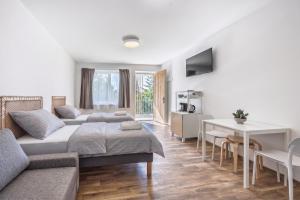 a living room with a couch and a table at DANUBike in Dobrohošť