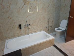 a bathroom with a bath tub and a toilet at Prem niwas in Kakarmatha