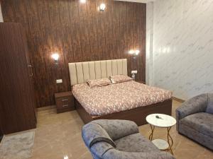 a bedroom with a bed and two couches at Prem niwas in Kakarmatha