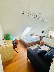 a bedroom with a bed and a couch in a room at Gästezimmer Traisen in Traisen