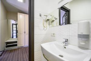 a white bathroom with a sink and a mirror at G40 Boutique Hotel in Odesa +33 photos
