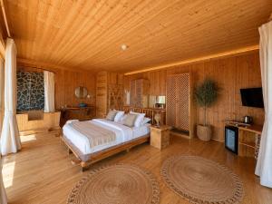 a bedroom with a large bed and a wooden ceiling at Heaven Resort Faralya in Fethiye