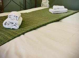a bed with towels on top of it at Donna Lucia Apulian Experience in Ruvo di Puglia