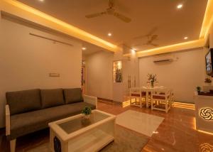 a living room with a couch and a table at The Collectors Loft in Jaipur +90 photos