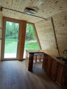 a kitchen with a table and a large window at A-frame family in Prokurava