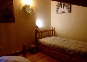 a bedroom with a bed and a mirror on the wall at La Fée Du Val - Gite En Ardèche in Rosières +18 photos