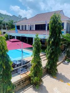 a house with a swimming pool and two trees at SixPoint Victoria in Kisumu