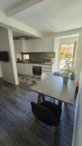 a kitchen with a wooden table and a dining room table sidx sidx sidx at Varenna Sweet Home in Varenna