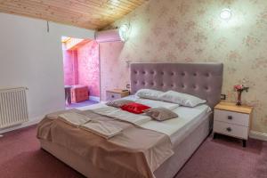 a bedroom with a large bed with two pillows on it at Hotel Boutique Casa Vermont in Bucharest +60 photos