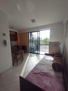 a living room with a large bed and a dining room at Apartamento en puerta del sol 17 in La Loma