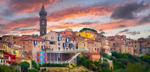a view of a city with a clock tower at Pura Apartment Hill View Stay near Peccioli & Lajatico in Palaia