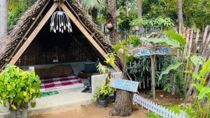 a resort room with a bed in a tree at C U Hostel in Trincomalee