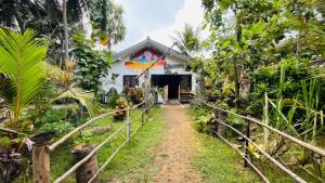 a building with a painting on the side of it at C U Hostel in Trincomalee