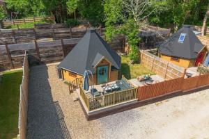 an aerial view of a small house with a fence at Woods Meadow Glamping in West Malling +26 photos
