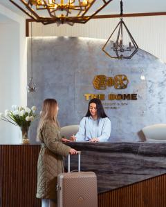 a woman talking to a woman with a suitcase at GetAp Resort Arzni in Arzni +45 photos