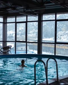 a boy swimming in a swimming pool in a building at GetAp Resort Arzni in Arzni