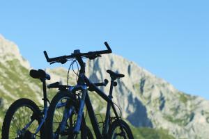 two bikes parked next to each other in front of a mountain at Hotel Hvala Superior - Topli Val in Kobarid