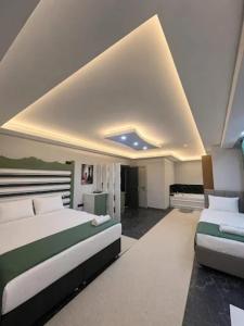 a large bedroom with two beds and a fireplace at David Moser 1878 Oteli in Kars